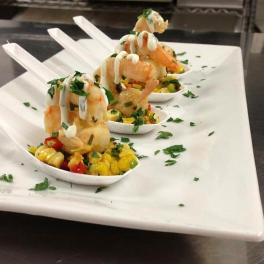 Perfect for special events, these white spoons feature shrimp, corn salsa, and fresh herbs.
